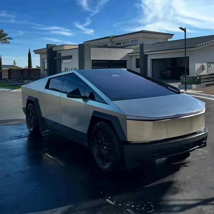 Silver Tesla Cybertruck detailed in a driveway